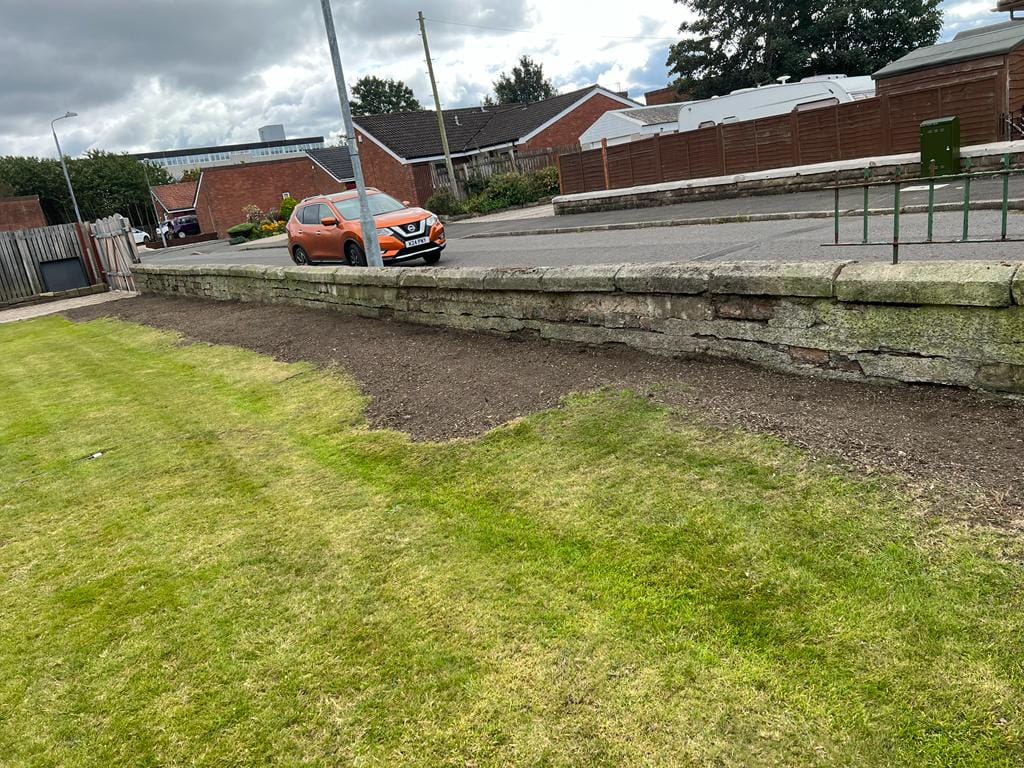 Old crumbling wall before replacement
